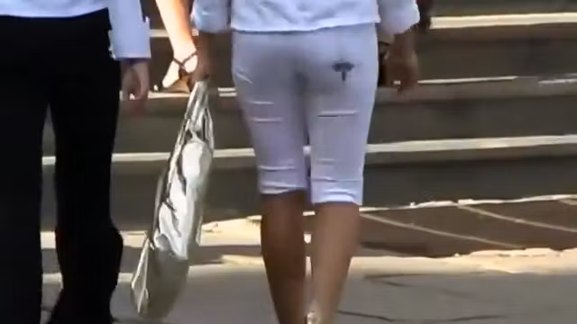 Checking out a fashionable girl's ass