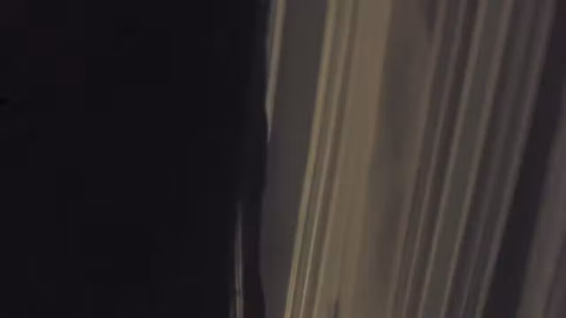 Girl in the window is sitting naked on the sofa