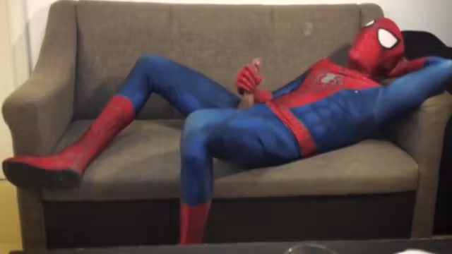 Horny Spiderman jerks off and cums massive load