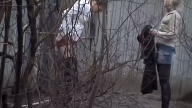 Hot girls piss behind an abandoned house