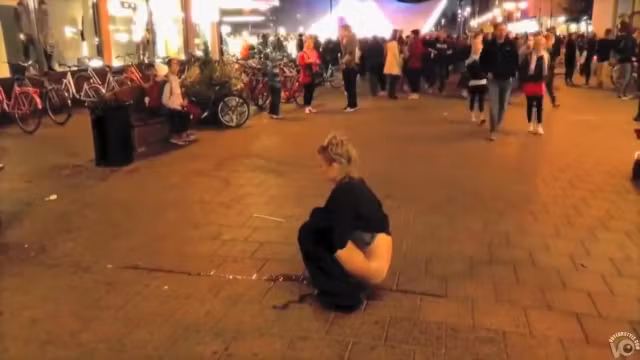 Brave blonde urinates on the middle of the crowded street!