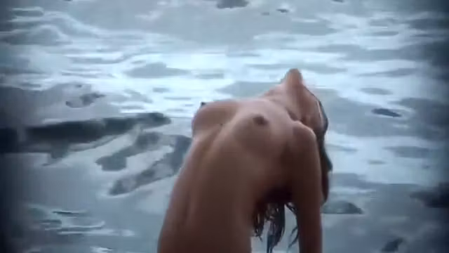 Firm topless girl stretching in the water
