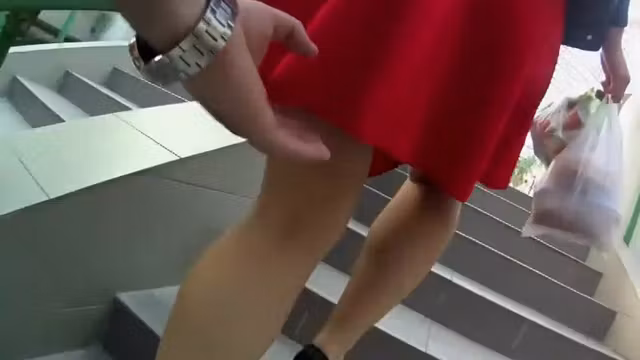 lifts skirt to see a naked butt