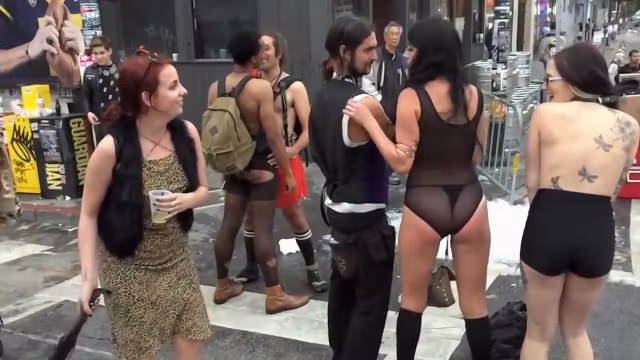 Inked topless babe offers herself for public whipping
