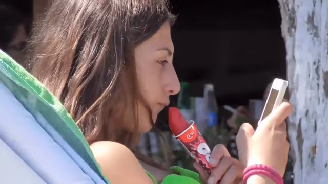 teen 18+ girl sucks on an ice cone