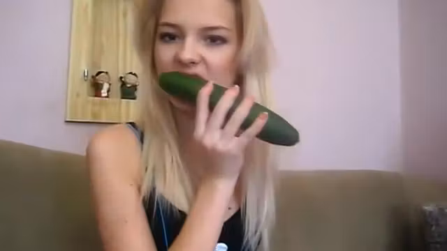 teen 18+ beauty plays with a cucumber