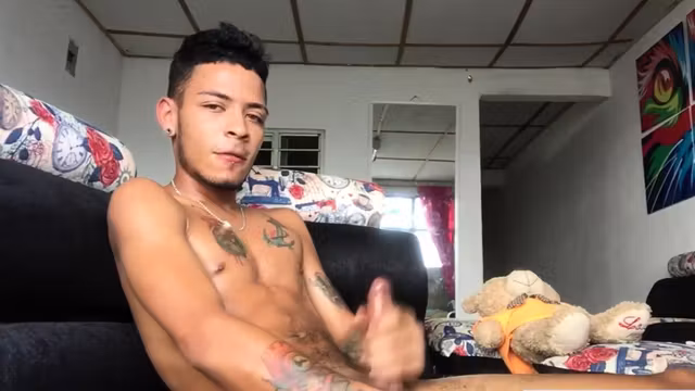 Inked Latin twink strokes his pecker