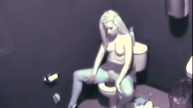 Sexy blonde on a toilet fingering her pussy