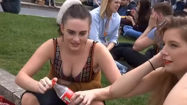 Busty girl smiles and waves at me